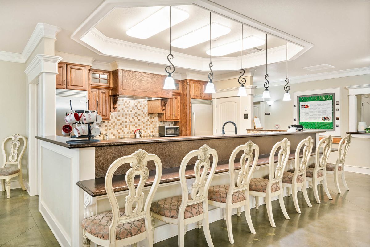 A modern kitchen with elegant bar stools and stylish lighting.