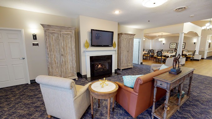 A cozy living room with a fireplace, television, and comfortable seating.