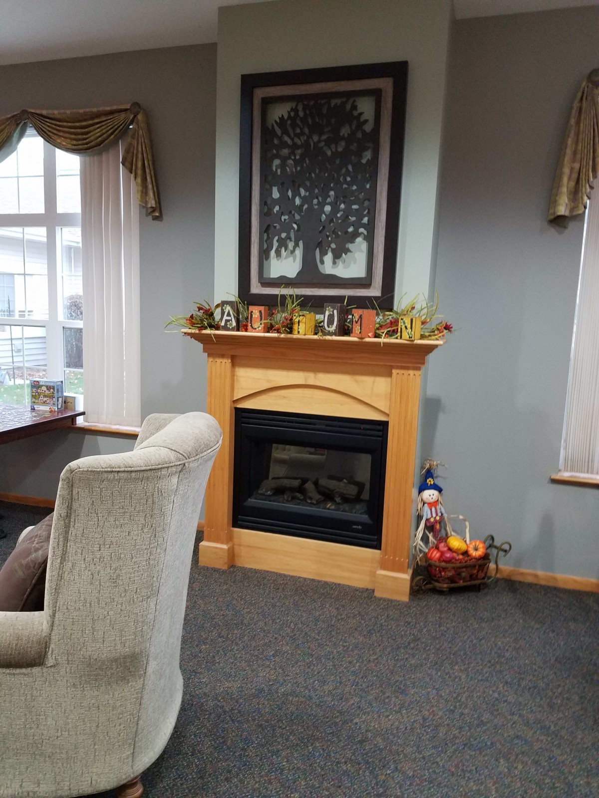 A cozy living room with a fireplace and comfortable seating.