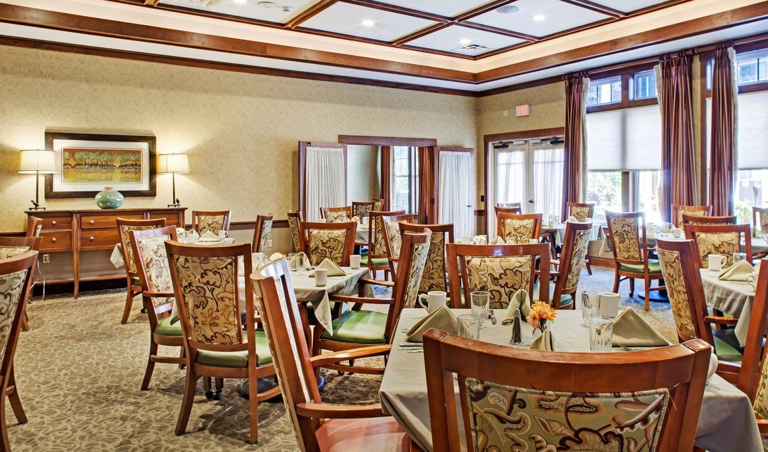 An elegant dining room with neatly arranged tables and chairs.