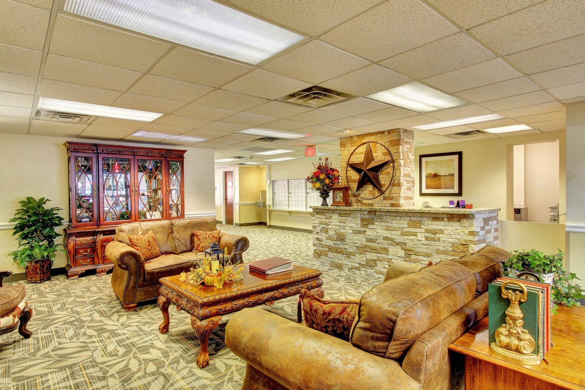 A well-furnished lobby with leather sofas and a decorative reception area.