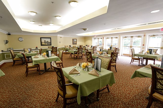 An elegantly decorated dining room with neatly arranged tables and chairs.