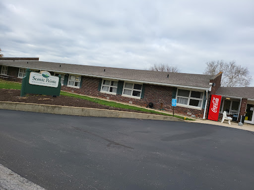 An exterior view of a residential building with signage and landscaped surroundings.