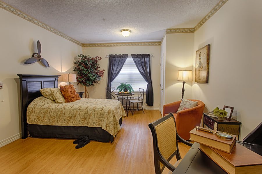 Cozy bedroom with a comfortable bed, wooden flooring, and elegant decor.