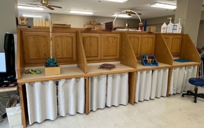 An organized workspace with wooden cabinets and craft supplies.