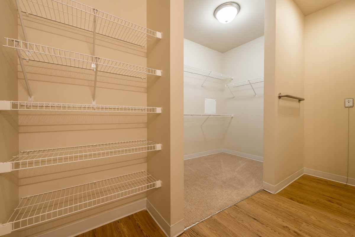 A spacious walk-in closet with wire shelving for organized storage.