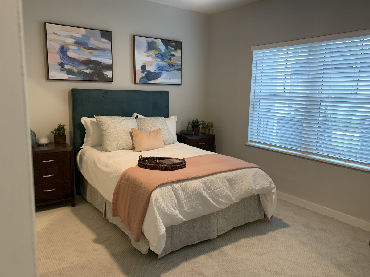 A cozy bedroom with stylish decor and natural light.