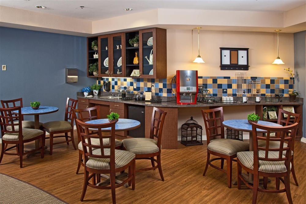 A cozy kitchen and dining area with wooden furniture and colorful tiles.