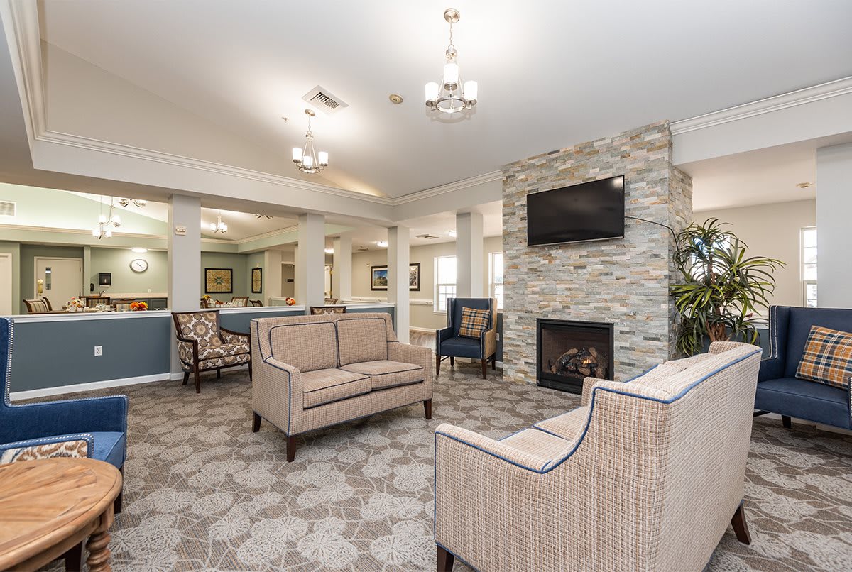 A modern living room with a fireplace and comfortable seating.