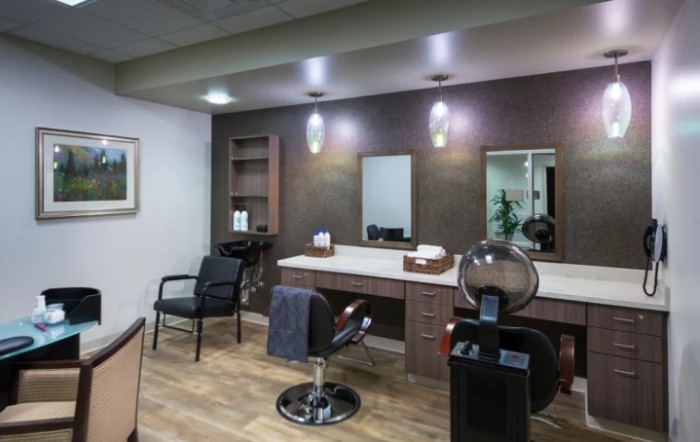 A modern hair salon interior with styling chairs and mirrors.