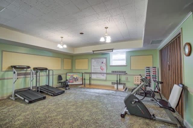 A well-equipped home gym with treadmills and weights.