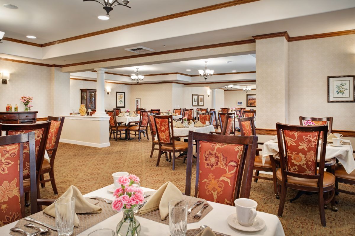 An elegant dining room with neatly arranged tables and chairs.
