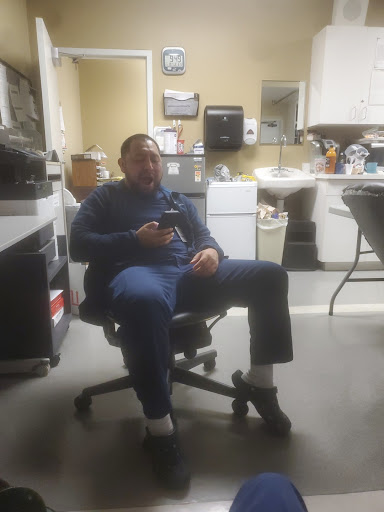 A man sitting comfortably in an office chair, enjoying a moment of relaxation in the workplace.