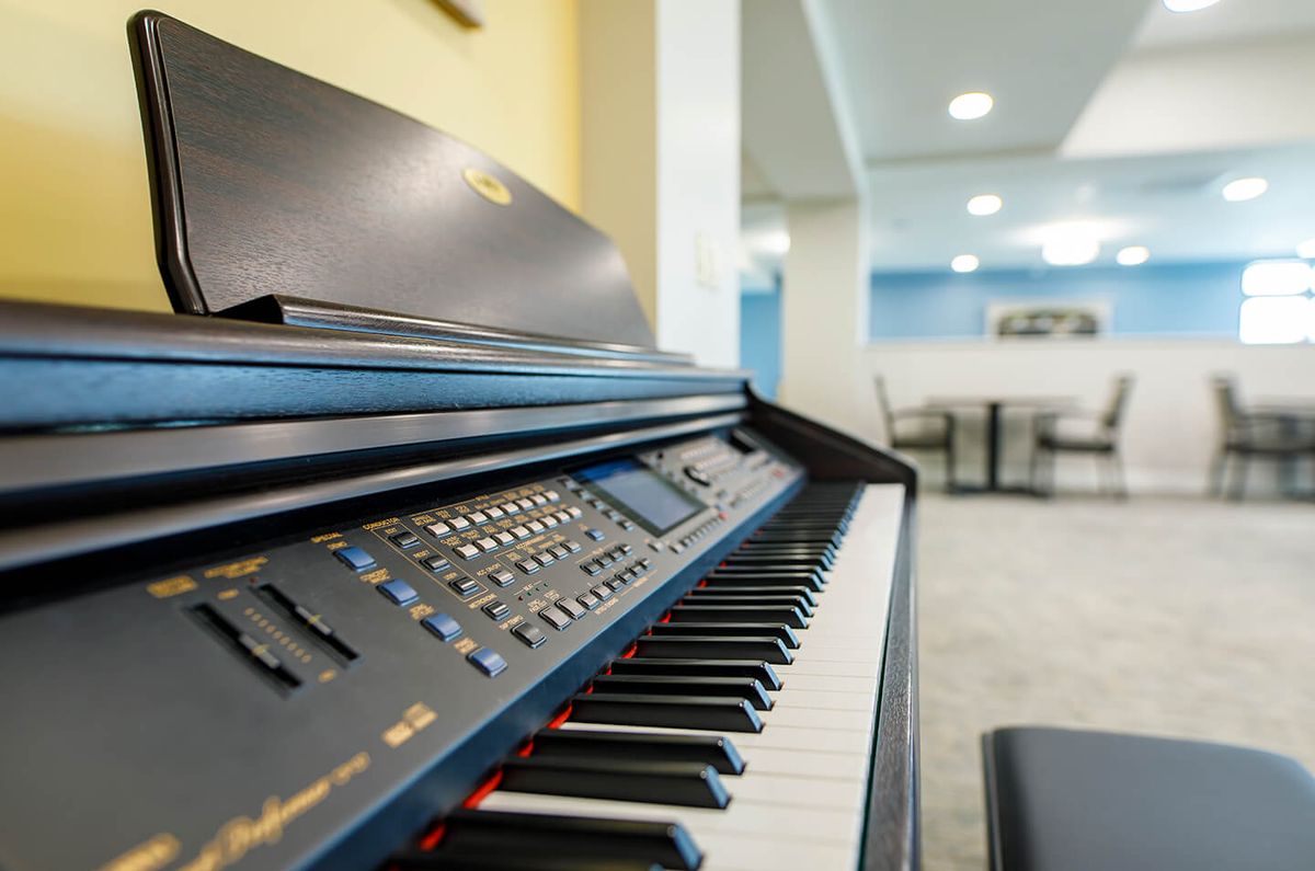 A close-up view of an electric piano in a music room.