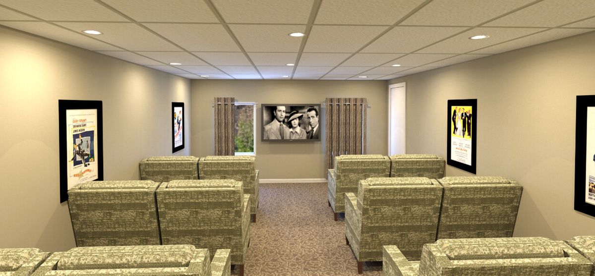 A cozy home theater room with comfortable seating and a large TV.