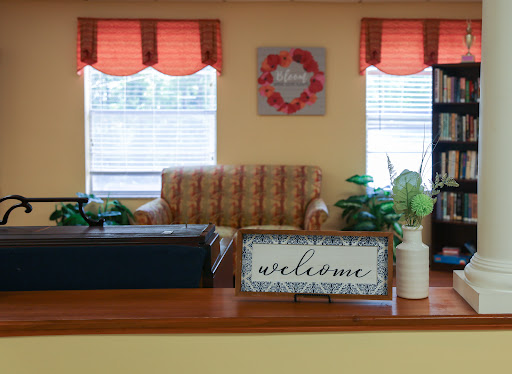 A cozy living room area featuring a welcoming ambiance with comfortable seating and decorative touches.