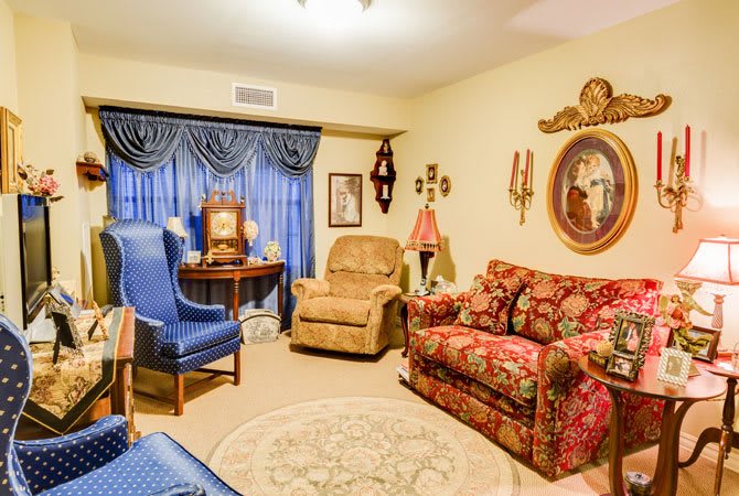 A cozy vintage-style living room with patterned furniture and classic decor elements.