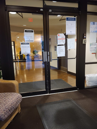 View of the entrance with glass doors leading into a spacious interior, decorated with signage.