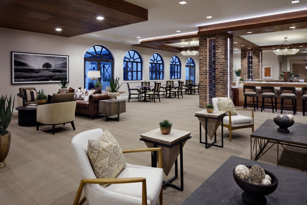 A modern lounge area with comfortable seating and large windows.