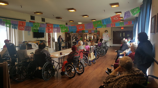 Seniors enjoying a lively event at a community center.