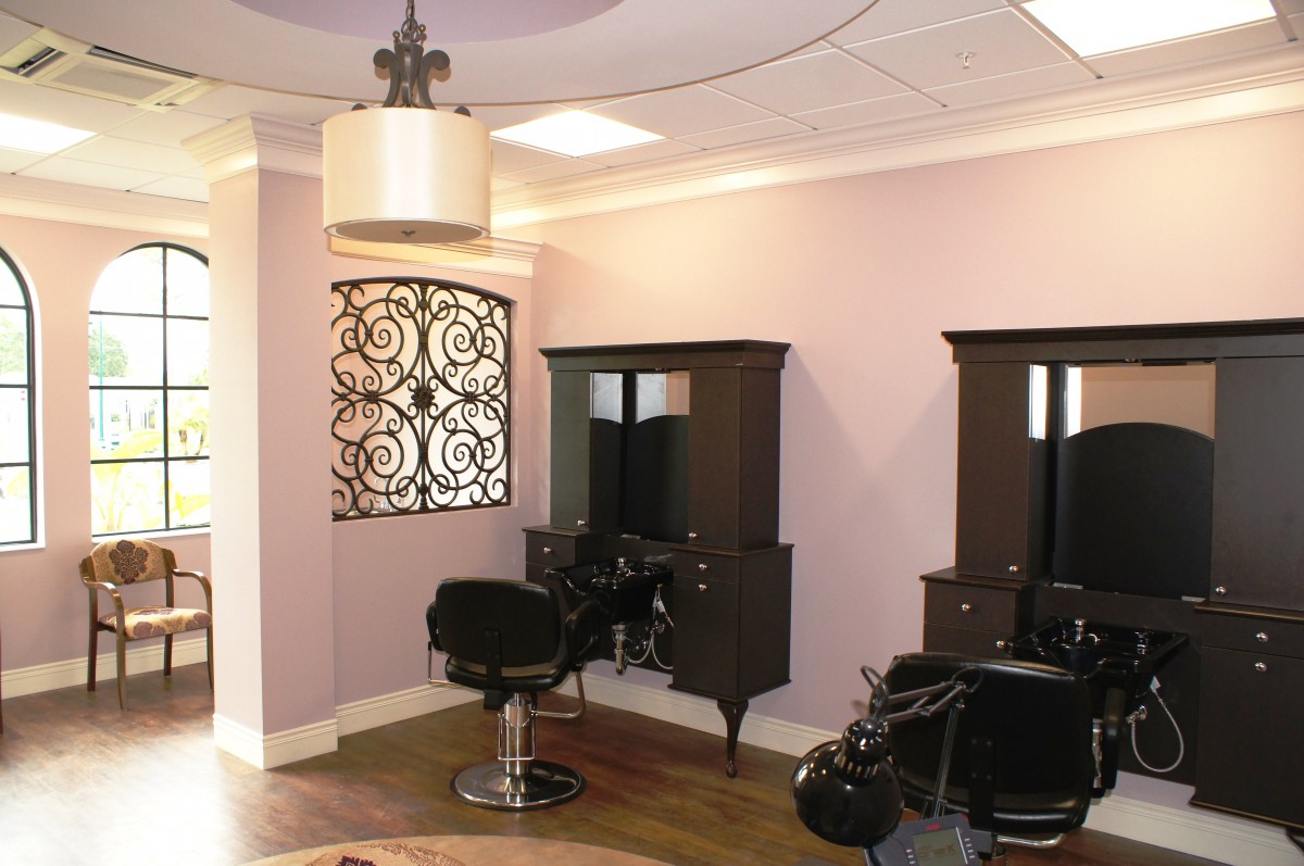 A modern hair salon interior with stylish decor and comfortable seating.