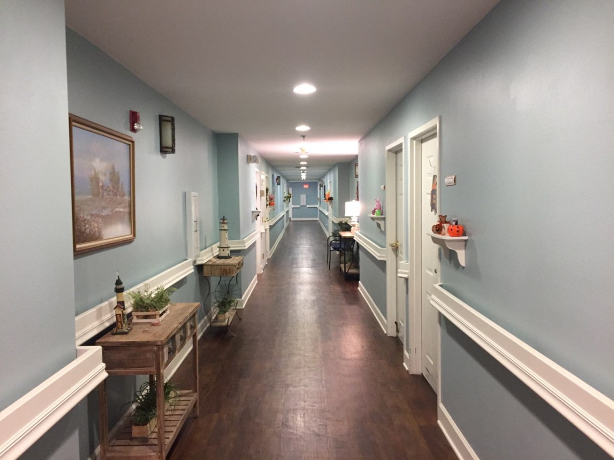 A well-lit, decoratively furnished hallway with multiple doors.
