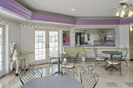 A bright and modern cafe interior featuring tables and chairs, with a welcoming atmosphere.