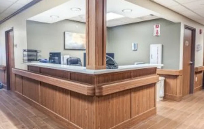 A wooden reception desk in an office setting.