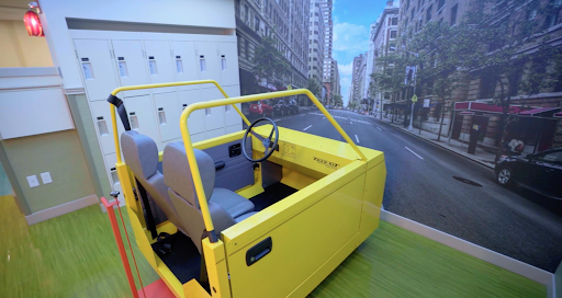A vibrant yellow toy car set against an urban-themed backdrop.