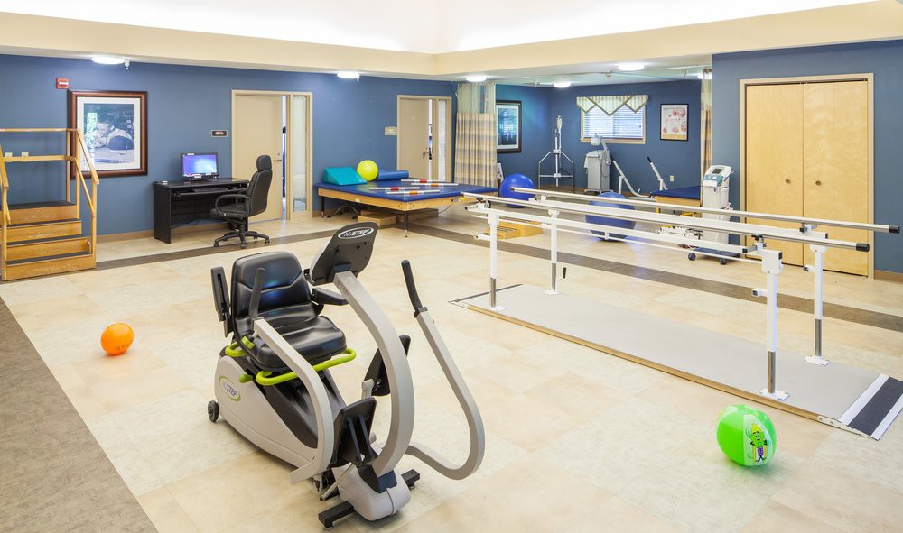 A well-equipped physical therapy room featuring various exercise and rehabilitation equipment.