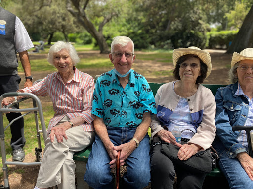 A joyful gathering of friends enjoying a sunny day at the park.