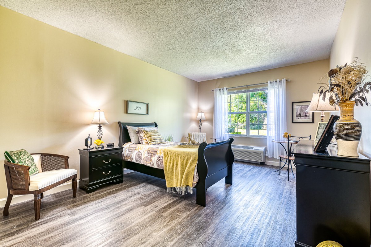 A cozy and modern bedroom with ample natural light and stylish furniture.