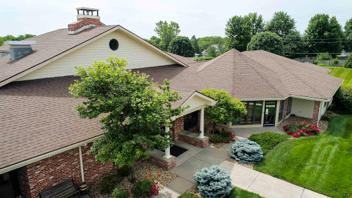 A picturesque view of a modern residential home, featuring lush landscaping and a welcoming entrance.
