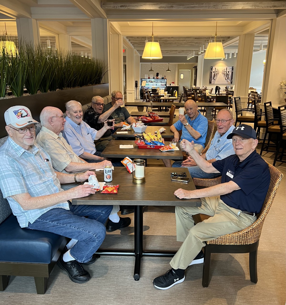 A group of elderly individuals enjoying a meal together in a restaurant setting.