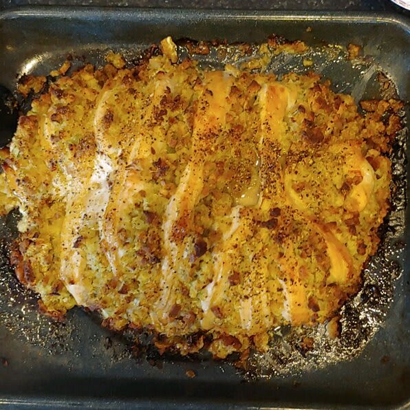Seasoned baked chicken in a roasting pan.