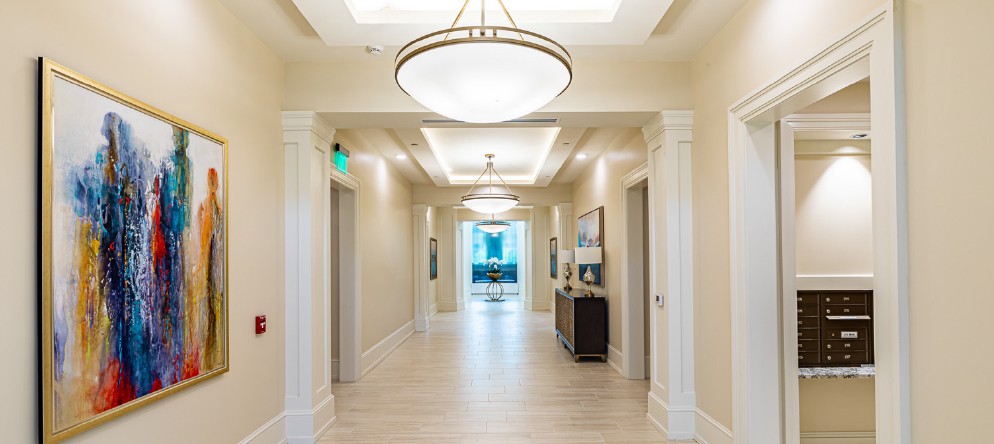 A modern hallway with elegant lighting and artwork on the walls.