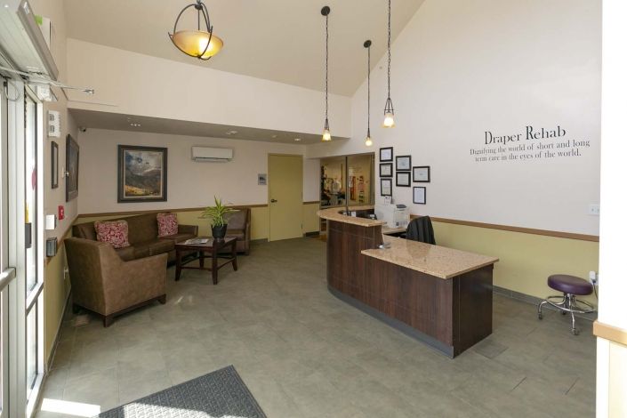 A modern reception area with a desk and waiting seating arrangement.