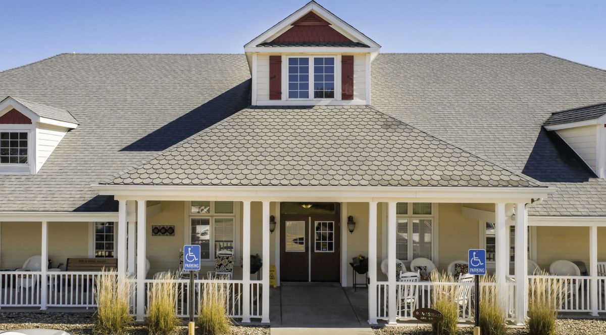 A charming house with a front porch and gabled roof.