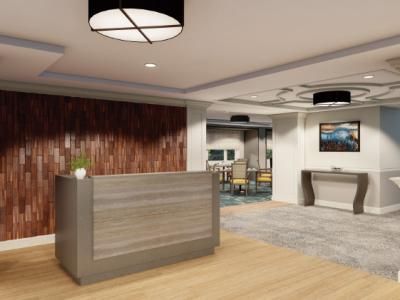 A modern hotel lobby with a reception desk and stylish decor.