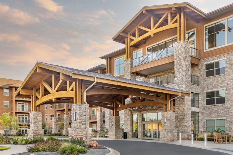 A modern building with a prominent wooden and stone entrance.