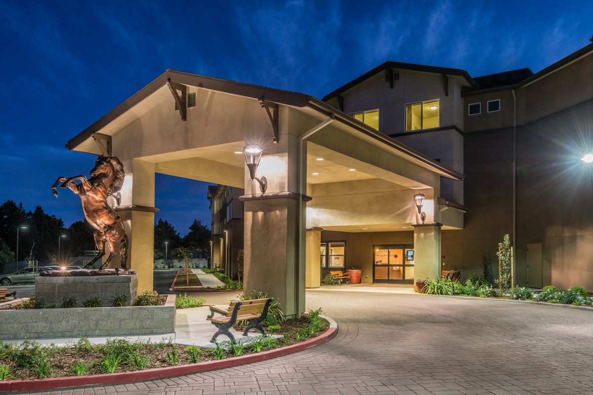 A well-lit hotel entrance at night.