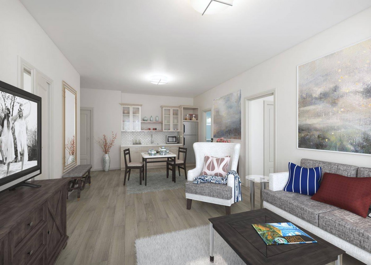 A modern living room with an open floor plan, featuring a dining area and contemporary furnishings in neutral tones.