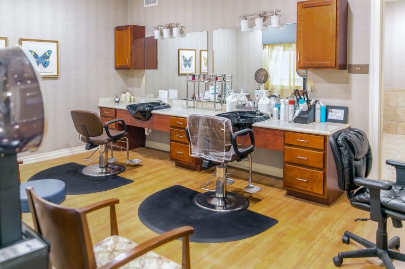 Interior of a modern barber shop with chairs and styling stations.