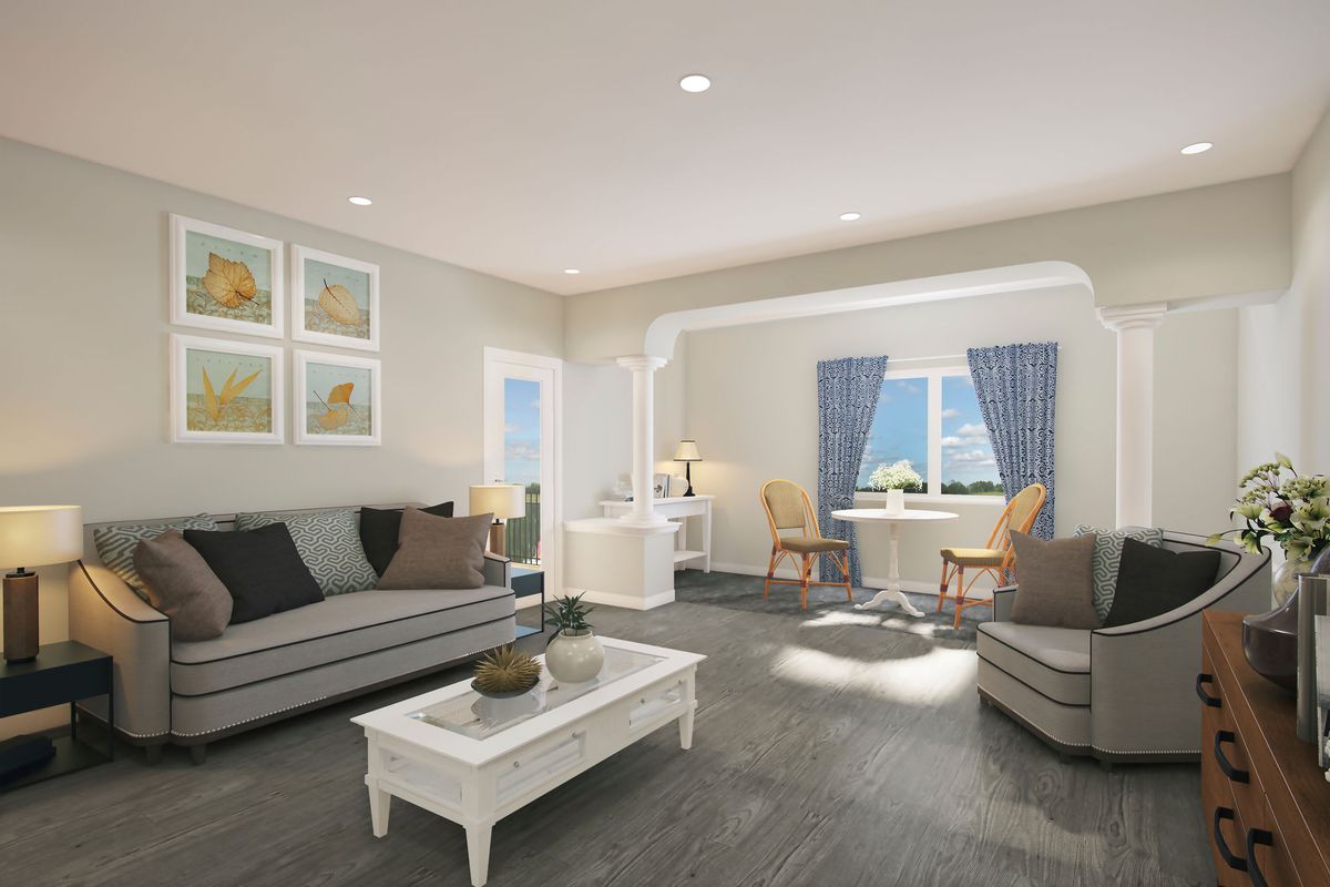 A modern living room with stylish furniture and ample natural light.