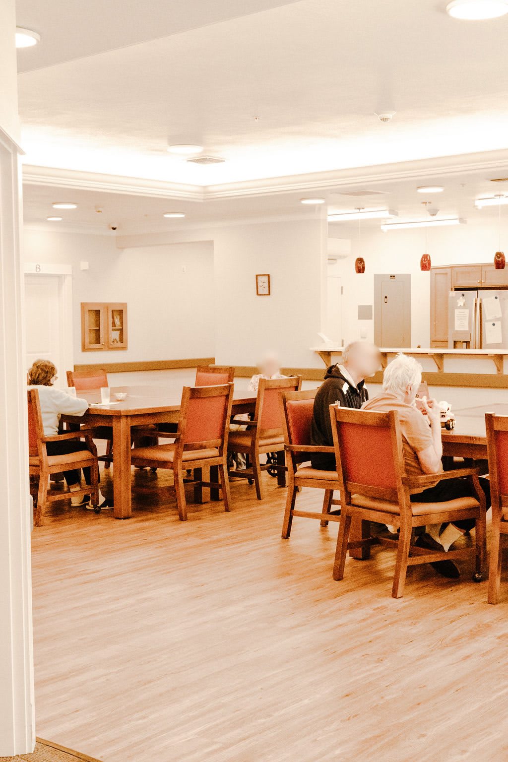 A cozy dining area with people seated at tables.