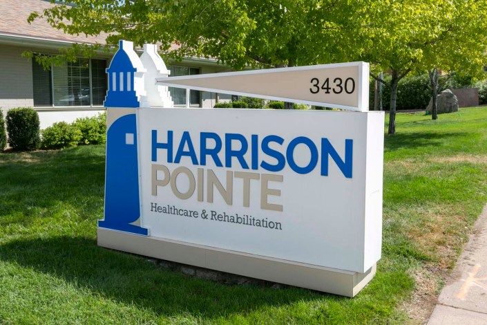 A sign for Harrison Pointe Healthcare & Rehabilitation Station.