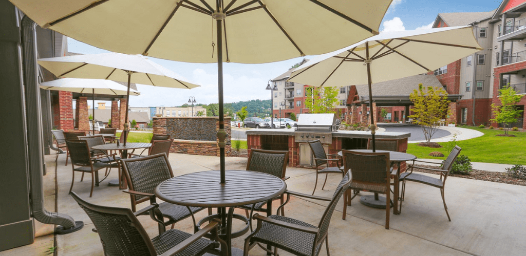 A scenic outdoor patio with tables and chairs under large umbrellas.