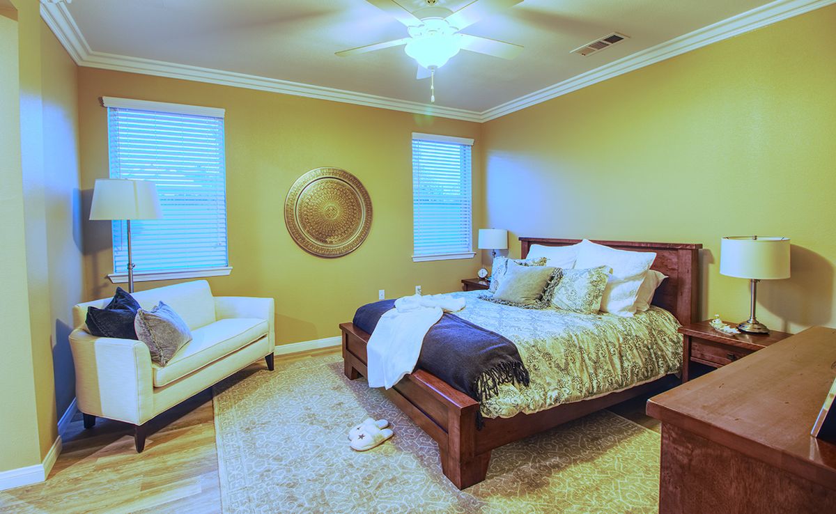 Cozy bedroom with elegant decor and warm lighting.