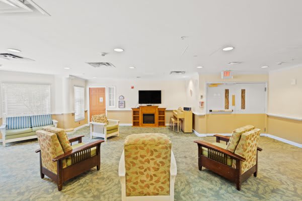A bright and welcoming lobby area with comfortable seating and a television.