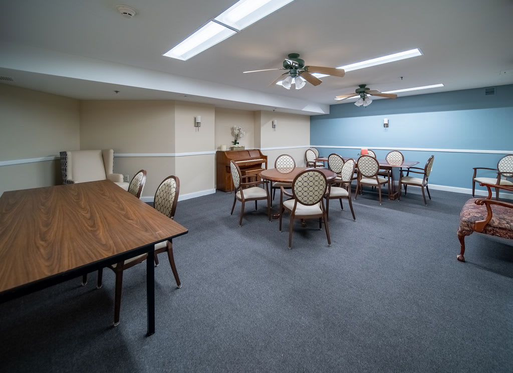 A spacious meeting room with tables and chairs arranged for conferences.